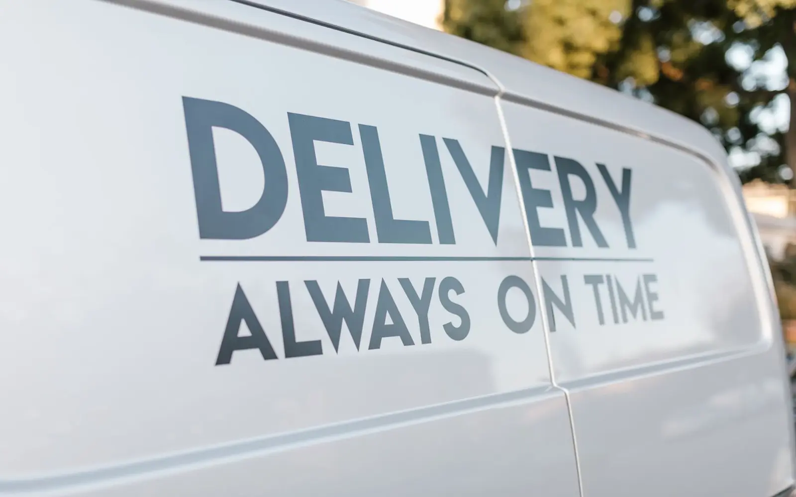 The side of a signwritten delivery van belonging to a small fleet