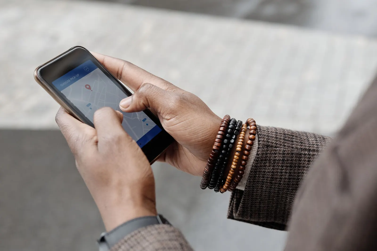 Hands using a map search on a smartphone