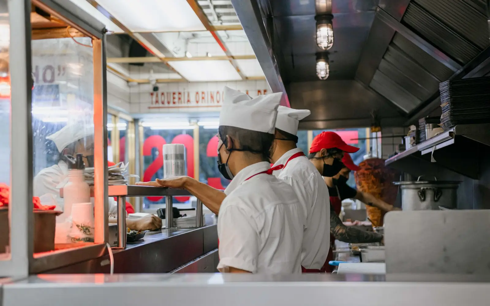 Kitchen staff working the line in a small restaurant